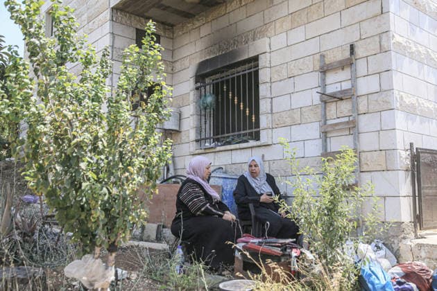 July 25, 2026, Nablus, West Bank, Palestine: Palestinian women sit outside their burned-out home, set ablaze by Jewish settlers in the village of Tell, southwest of Nablus in the West Bank. This attack came in retaliation for the killing of two settlers and four Palestinians in Tell, southwest of Nablus in the West Bank. In response, settlers set fire to Palestinian cars and homes in Tell and the neighboring village of Qalqilya Sara. Meanwhile, the Israeli army announced its readiness for a military operation in the northern West Bank, which is under the control of the Palestinian Authority. Nablus Palestine - ZUMAs197 20260725_aaa_s197_256 Copyright: xNasserxishatyehx