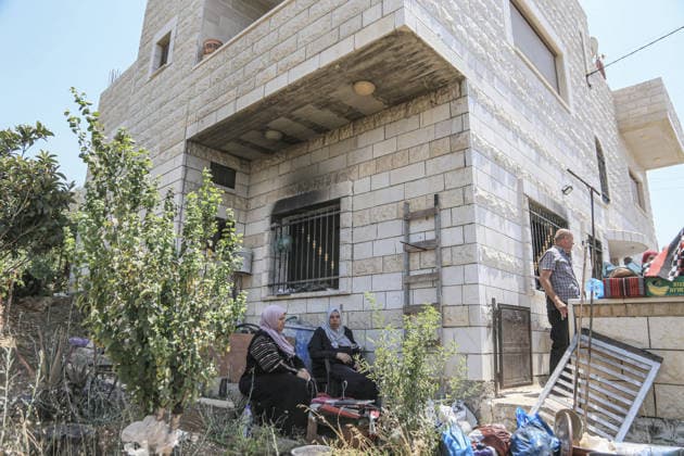 July 25, 2026, Nablus, West Bank, Palestine: Palestinian women sit outside their burned-out home, set ablaze by Jewish settlers in the village of Tell, southwest of Nablus in the West Bank. This attack came in retaliation for the killing of two settlers and four Palestinians in Tell, southwest of Nablus in the West Bank. In response, settlers set fire to Palestinian cars and homes in Tell and the neighboring village of Qalqilya Sara. Meanwhile, the Israeli army announced its readiness for a military operation in the northern West Bank, which is under the control of the Palestinian Authority. Nablus Palestine - ZUMAs197 20260725_aaa_s197_259 Copyright: xNasserxishatyehx