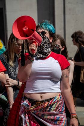 July 25, 2026, London, Westminster, United Kingdom: An activist shouts through a megaphone during the Trans+ Pride London march. Thousands of people joined the seventh annual Trans+ Pride march and rally in central London. The event celebrated the trans community while promoting equality and challenging discrimination through visibility and collective action. The march set off from Langham Place at 2 p.m., paused at three points for speeches and to welcome additional participants, and concluded with a rally and further speeches in Trafalgar Square. London United Kingdom - ZUMAs197 20260725_aaa_s197_278 Copyright: xJamesxWilloughbyx
