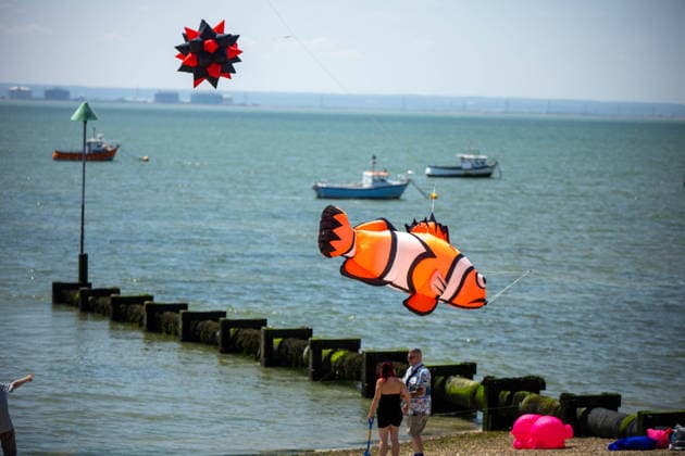 July 25, 2026, Essex, United Kingdom: An inflatable clownfish kite and a black-and-red spiky ball kite fly above the sea and moored fishing boats during the Kite Festival at Southend-on-Sea, as spectators watch from the shoreline. The Kite Festival Southend s Alternative Airshow, organised by Project Southchurch, was held on the Eastern Esplanade at Thorpe Bay seafront, Southend-On-Sea, Essex. Essex United Kingdom - ZUMAs197 20260725_aaa_s197_413 Copyright: xIanxDavidsonx