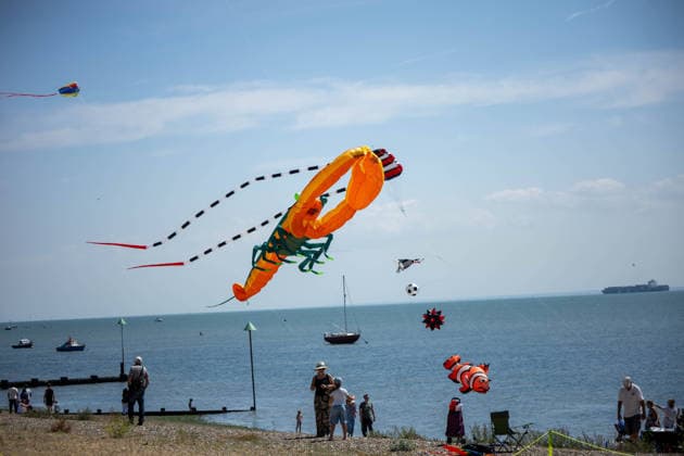July 25, 2026, Essex, United Kingdom: A giant orange lobster kite flies above the beach and sea during the Kite Festival at Southend-On-Sea, alongside a red parafoil with striped tails, a clownfish, a football kite and a flame-patterned dragon, as spectators watch from the shore. The Kite Festival Southend s Alternative Airshow, organised by Project Southchurch, was held on the Eastern Esplanade at Thorpe Bay seafront, Southend-On-Sea, Essex. Essex United Kingdom - ZUMAs197 20260725_aaa_s197_425 Copyright: xIanxDavidsonx