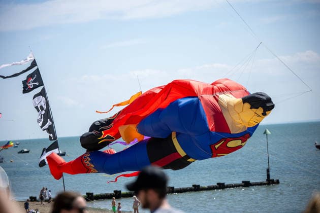 July 25, 2026, Essex, United Kingdom: A giant Superman-shaped kite flies low over the beach during the Kite Festival at Southend-On-Sea, with a skull-and-crossbones flag and spectators along the shore. The Kite Festival Southend s Alternative Airshow, organised by Project Southchurch, was held on the Eastern Esplanade at Thorpe Bay seafront, Southend-On-Sea, Essex. Essex United Kingdom - ZUMAs197 20260725_aaa_s197_423 Copyright: xIanxDavidsonx