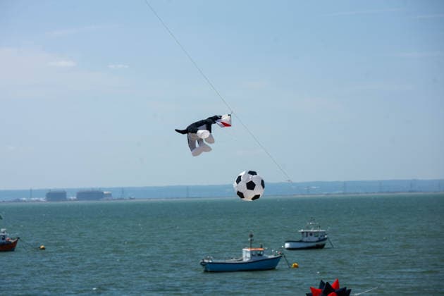 July 25, 2026, Essex, United Kingdom: A dog-shaped kite and a football-shaped kite fly above the sea and moored fishing boats during the Kite Festival at Southend-On-Sea. The Kite Festival Southend s Alternative Airshow, organised by Project Southchurch, was held on the Eastern Esplanade at Thorpe Bay seafront, Southend-On-Sea, Essex. Essex United Kingdom - ZUMAs197 20260725_aaa_s197_429 Copyright: xIanxDavidsonx