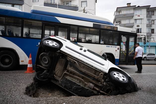 Heavy rainfall causes flooding, road collapse in Ankara ANKARA, TURKIYE - JULY 25: A car is seen trapped in a sinkhole after the road collapsed following heavy rainfall in Ankara, Turkiye, on July 25, 2026. Intense morning downpours caused sections of the road to give way, leaving the vehicle partially submerged. Muhammed Abdullah Kurtar Anadolu Ankara Turkey. Editorial use only. Please get in touch for any other usage.  Copyright: x2026xAnadoluxMuhammedxAbdullahxKurtarx