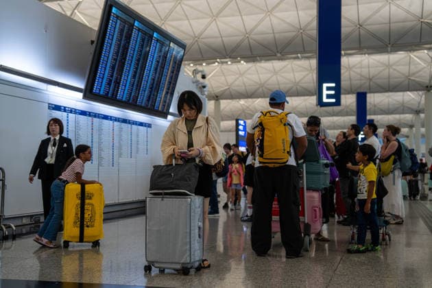HONGKONG-TYPHOON NOUL Travelers looking at a flight information display board inside terminal 1 at Hong Kong International Airpot during typhoon Noul in Hong Kong, July 26, 2026. NEXPHER Vernon Yuen HONG KONG