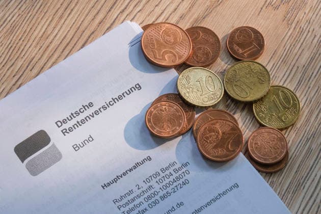 Nahaufnahme eines Briefkopfes der Deutschen Rentenversicherung Bund auf einem Holzuntergrund, auf dem eine kleine Ansammlung von Euro-Cent-Münzen (Kupfergeld und Messingmünzen) liegt. *** A close-up of a letterhead from the German Federal Pension Insurance Fund on a wooden surface, on which lies a small pile of euro cent coins (copper and brass coins). Nordrhein-Westfalen Deutschland, Germany 20260725-DSCF7792