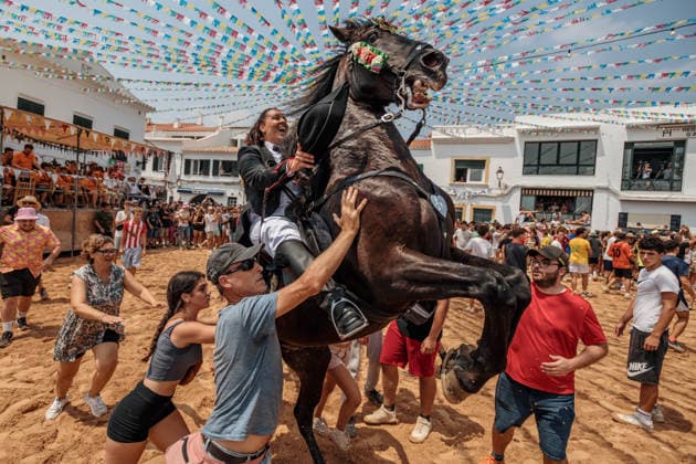 July 26, 2026, Fornells, Menorca Balearic Islands, Spain: A caixer, or horse rider, rears his horse amid a cheering crowd during the traditional Jaleo at the Sant Antoni Festival in Fornells. Fornells Spain  - ZUMAo105 20260726_fap_o105_001 Copyright: xMatthiasxOesterlex