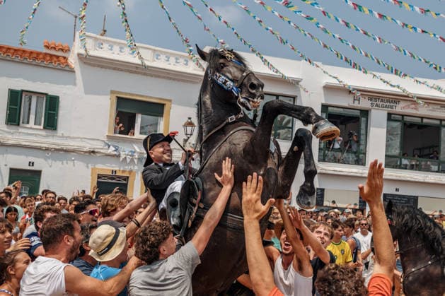 July 26, 2026, Fornells, Menorca Balearic Islands, Spain: A caixer, or horse rider, rears his horse amid a cheering crowd during the traditional Jaleo at the Sant Antoni Festival in Fornells. Fornells Spain  - ZUMAo105 20260726_fap_o105_002 Copyright: xMatthiasxOesterlex