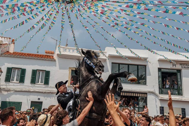 July 26, 2026, Fornells, Menorca Balearic Islands, Spain: A caixer, or horse rider, rears his horse amid a cheering crowd during the traditional Jaleo at the Sant Antoni Festival in Fornells. Fornells Spain  - ZUMAo105 20260726_fap_o105_005 Copyright: xMatthiasxOesterlex