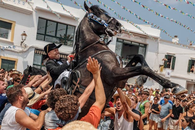 July 26, 2026, Fornells, Menorca Balearic Islands, Spain: A caixer, or horse rider, rears his horse amid a cheering crowd during the traditional Jaleo at the Sant Antoni Festival in Fornells. Fornells Spain  - ZUMAo105 20260726_fap_o105_006 Copyright: xMatthiasxOesterlex