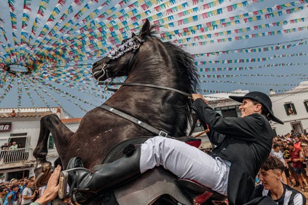 July 26, 2026, Fornells, Menorca Balearic Islands, Spain: A caixer, or horse rider, rears his horse amid a cheering crowd during the traditional Jaleo at the Sant Antoni Festival in Fornells. Fornells Spain  - ZUMAo105 20260726_fap_o105_007 Copyright: xMatthiasxOesterlex