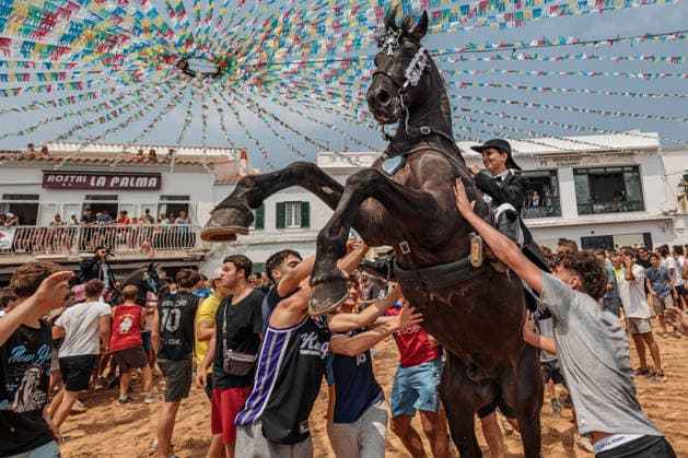 July 26, 2026, Fornells, Menorca Balearic Islands, Spain: A caixer, or horse rider, rears his horse amid a cheering crowd during the traditional Jaleo at the Sant Antoni Festival in Fornells. Fornells Spain  - ZUMAo105 20260726_fap_o105_009 Copyright: xMatthiasxOesterlex