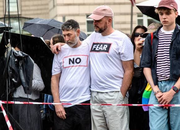 July 26, 2026, Berlin, Germany: BERLIN, GERMANY Ã¢â‚¬ JULY 26, 2026: People attend a vigil at the Brandenburg Gate in Berlin, Germany, following the deadly attack near the city s Christopher Street Day Pride celebrations a day earlier. Mourners laid flowers, candles, signs and LGBTQ+ pride flags in memory of the victims after a vehicle drove into a crowd, killing one person and injuring dozens. German authorities continued searching for the main suspect, identified as Abdul Ballout, whom police said had ties to Islamist extremist circles. Berlin Germany - ZUMAq101 20260726_zna_q101_098 Copyright: xAndro SxTrujillox
