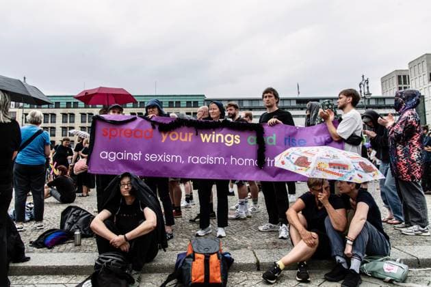 July 26, 2026, Berlin, Germany: BERLIN, GERMANY Ã¢â‚¬ JULY 26, 2026: People attend a vigil at the Brandenburg Gate in Berlin, Germany, following the deadly attack near the city s Christopher Street Day Pride celebrations a day earlier. Mourners laid flowers, candles, signs and LGBTQ+ pride flags in memory of the victims after a vehicle drove into a crowd, killing one person and injuring dozens. German authorities continued searching for the main suspect, identified as Abdul Ballout, whom police said had ties to Islamist extremist circles. Berlin Germany - ZUMAq101 20260726_zna_q101_107 Copyright: xAndro SxTrujillox