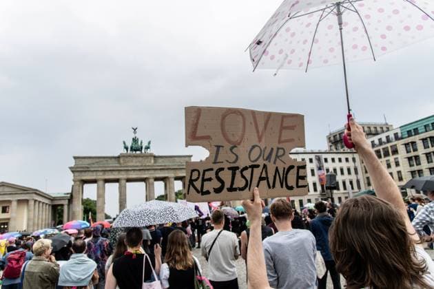 July 26, 2026, Berlin, Germany: BERLIN, GERMANY Ã¢â‚¬ JULY 26, 2026: People attend a vigil at the Brandenburg Gate in Berlin, Germany, following the deadly attack near the city s Christopher Street Day Pride celebrations a day earlier. Mourners laid flowers, candles, signs and LGBTQ+ pride flags in memory of the victims after a vehicle drove into a crowd, killing one person and injuring dozens. German authorities continued searching for the main suspect, identified as Abdul Ballout, whom police said had ties to Islamist extremist circles. Berlin Germany - ZUMAq101 20260726_zna_q101_109 Copyright: xAndro SxTrujillox