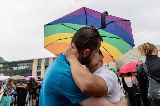 July 26, 2026, Berlin, Germany: BERLIN, GERMANY Ã¢â‚¬ JULY 26, 2026: People attend a vigil at the Brandenburg Gate in Berlin, Germany, following the deadly attack near the city s Christopher Street Day Pride celebrations a day earlier. Mourners laid flowers, candles, signs and LGBTQ+ pride flags in memory of the victims after a vehicle drove into a crowd, killing one person and injuring dozens. German authorities continued searching for the main suspect, identified as Abdul Ballout, whom police said had ties to Islamist extremist circles. Berlin Germany - ZUMAq101 20260726_zna_q101_111 Copyright: xAndro SxTrujillox
