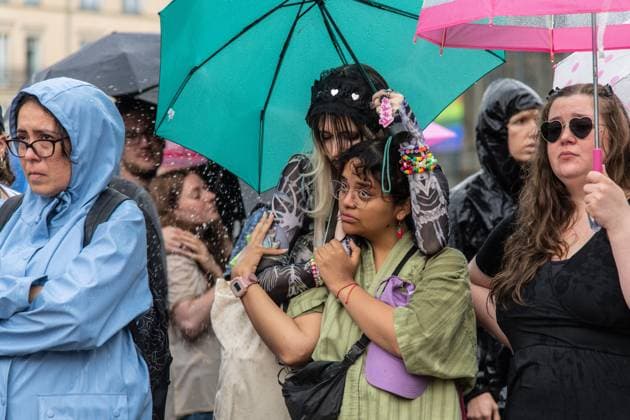 July 26, 2026, Berlin, Germany: BERLIN, GERMANY Ã¢â‚¬ JULY 26, 2026: People attend a vigil at the Brandenburg Gate in Berlin, Germany, following the deadly attack near the city s Christopher Street Day Pride celebrations a day earlier. Mourners laid flowers, candles, signs and LGBTQ+ pride flags in memory of the victims after a vehicle drove into a crowd, killing one person and injuring dozens. German authorities continued searching for the main suspect, identified as Abdul Ballout, whom police said had ties to Islamist extremist circles. Berlin Germany - ZUMAq101 20260726_zna_q101_114 Copyright: xAndro SxTrujillox