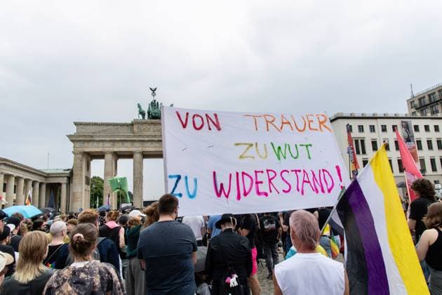 July 26, 2026, Berlin, Germany: BERLIN, GERMANY Ã¢â‚¬ JULY 26, 2026: People attend a vigil at the Brandenburg Gate in Berlin, Germany, following the deadly attack near the city s Christopher Street Day Pride celebrations a day earlier. Mourners laid flowers, candles, signs and LGBTQ+ pride flags in memory of the victims after a vehicle drove into a crowd, killing one person and injuring dozens. German authorities continued searching for the main suspect, identified as Abdul Ballout, whom police said had ties to Islamist extremist circles. Berlin Germany - ZUMAq101 20260726_zna_q101_117 Copyright: xAndro SxTrujillox