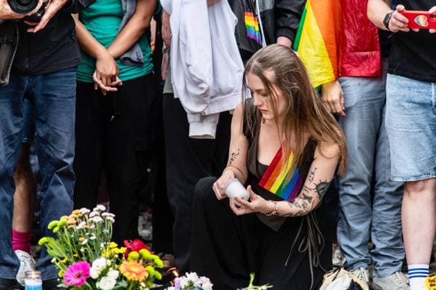 July 26, 2026, Berlin, Germany: BERLIN, GERMANY Ã¢â‚¬ JULY 26, 2026: People attend a vigil at the Brandenburg Gate in Berlin, Germany, following the deadly attack near the city s Christopher Street Day Pride celebrations a day earlier. Mourners laid flowers, candles, signs and LGBTQ+ pride flags in memory of the victims after a vehicle drove into a crowd, killing one person and injuring dozens. German authorities continued searching for the main suspect, identified as Abdul Ballout, whom police said had ties to Islamist extremist circles. Berlin Germany - ZUMAq101 20260726_zna_q101_118 Copyright: xAndro SxTrujillox