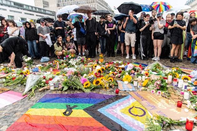 July 26, 2026, Berlin, Germany: BERLIN, GERMANY Ã¢â‚¬ JULY 26, 2026: People attend a vigil at the Brandenburg Gate in Berlin, Germany, following the deadly attack near the city s Christopher Street Day Pride celebrations a day earlier. Mourners laid flowers, candles, signs and LGBTQ+ pride flags in memory of the victims after a vehicle drove into a crowd, killing one person and injuring dozens. German authorities continued searching for the main suspect, identified as Abdul Ballout, whom police said had ties to Islamist extremist circles. Berlin Germany - ZUMAq101 20260726_zna_q101_120 Copyright: xAndro SxTrujillox