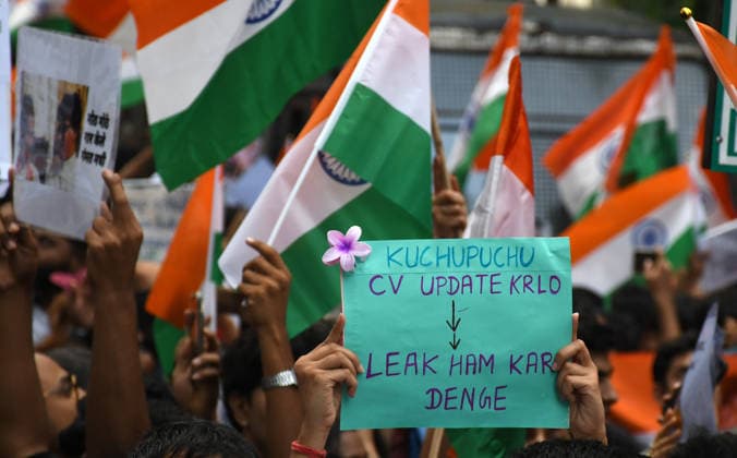 July 26, 2026, Mumbai, Maharashtra, India: A citizen seen holding a placard and others holding Indian national flags during the celebration held after the resignation of Union Education Minister Dharmendra Pradhan. Youth led Cockroach Janata Party (CJP) protest which lasted for 36 days concluded on July 25 2026 after the government accepted the key demands put forth by leaders of Cockroach Janata Party (CJP) alongside resignation of Union Education Minister Dharmendra Pradhan in alleged paper leaks and irregularities found in major national medical entrance examinations. Mumbai India  - ZUMAs197 20260726_aaa_s197_042 Copyright: xAshishxVaishnavx