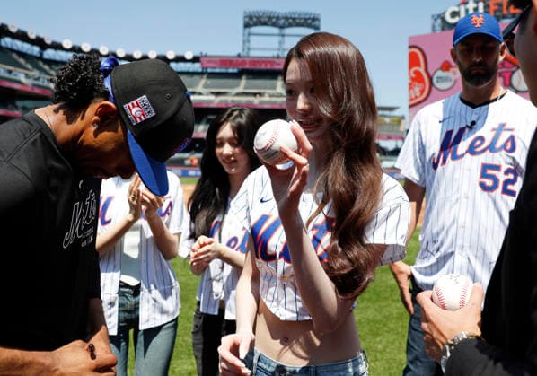 Jang Won-young of the K-pop girl group Ive stands on the field before throwing out the first pitch when the Los Angeles Dodgers play the New York Mets at Citi Field on Sunday, July 26, 2026 in New York City.  NYP20260726113 JOHNxANGELILLO