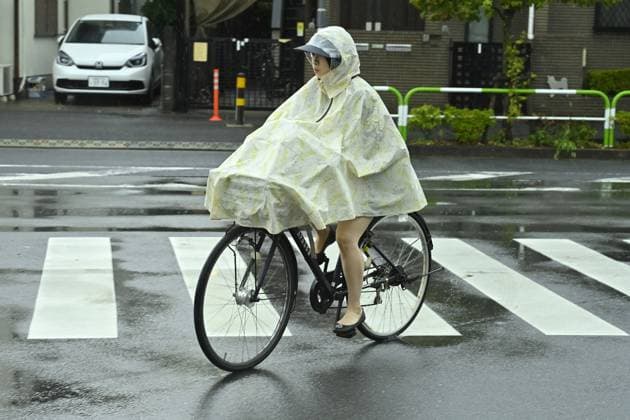 Sudden summer thunderstorm interrupts relief from Tokyo heat TOKYO, JAPAN - JULY 26 : A cyclist wearing a rain poncho crosses a street during heavy rain in Tokyo, Japan, on July 26, 2026. The Japan Meteorological Agency issued a thunderstorm advisory for parts of the capital as unstable weather followed a period of intense summer heat. David Mareuil Anadolu Tokyo Japan. Editorial use only. Please get in touch for any other usage.  Copyright: x2026xAnadoluxDavidxMareuilx