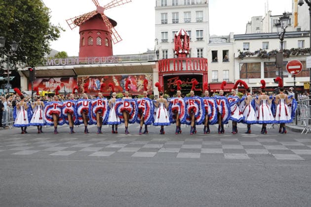 Tour de France cyclists pass by the Moulin Rouge during the final stage in Paris on July 26, 2026. The Moulin Rouge dancers perform before the Tour de France cyclists pass by. On this exceptional occasion, the famous Moulin Rouge dancers step out in front of the cabaret to put on a unique show. Dressed in their flamboyant tricolor costumes, they perform their iconic French Cancan to cheer on the cyclists as they enter the final stretch of their epic journey Marc Ausset Lacroix Bestimage Tour de France riders passing the Moulin Rouge during the final stage in Paris on July 26, 2026—Moulin Rouge dancers perform before the riders pass by For this special occasion, the famous Moulin Rouge dancers step out in front of the cabaret to put on a un  Copyright: xMarcxAussetxLacroixx xBestimagexMarcxAussetxLacroixx xBestimagex