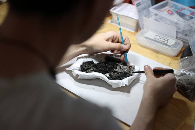 Gold amulet, ancient seal unearthed at Turkmen Karahoyuk excavation in Turkiye s Konya KONYA, TURKIYE - JULY 26: An archaeologist cleans an artifact unearthed during excavations at the Turkmen Karahoyuk archaeological site in the Cumra district of Konya, Turkiye, on July 26, 2026. Archaeologists conducting excavations at the ancient settlement recently uncovered a 3,500-year-old seal inscribed with Luwian hieroglyphs and a gold amulet dating to the Roman period, along with various other artifacts. Serhat Cetinkaya Anadolu Konya Turkey. Editorial use only. Please get in touch for any other usage.  Copyright: x2026xAnadoluxSerhatxCetinkayax