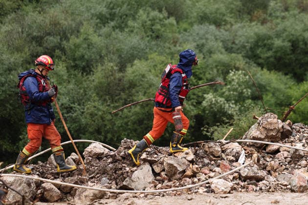 (260727) -- WEIYUAN, July 27, 2026 -- Rescuers work at the flood-hit area in Weiyuan County, northwest China s Gansu Province, July 27, 2026. The flash flood, triggered by sudden heavy rainfall, hit a scenic area in Weiyuan County, Dingxi City, on Sunday afternoon, leaving 10 people dead and 23 injured as of 6 p.m. ? ?Some tourists were camping in the scenic area and were trapped after the flood burst out, local authorities said. ? ?A total of 305 rescue personnel with 68 vehicles from the national comprehensive fire and rescue teams are conducting rescue operations at the site, according to the MEM. ) (SpotNews) CHINA-GANSU-WEIYUAN-FLASH FLOOD-RESCUE AND RELIEF WORK (CN) ChenxBin 
