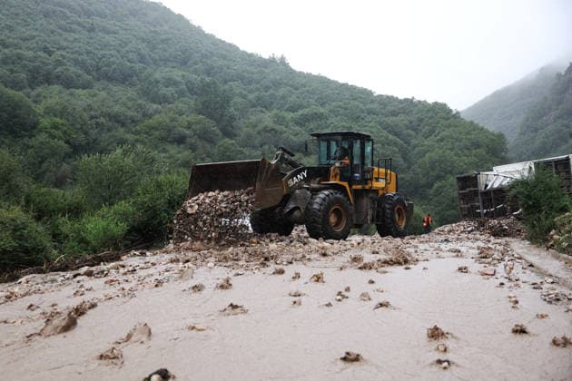 (260727) -- WEIYUAN, July 27, 2026 -- A machinery cleans up silt at the flood-hit area in Weiyuan County, northwest China s Gansu Province, July 27, 2026. The flash flood, triggered by sudden heavy rainfall, hit a scenic area in Weiyuan County, Dingxi City, on Sunday afternoon, leaving 10 people dead and 23 injured as of 6 p.m. ? ?Some tourists were camping in the scenic area and were trapped after the flood burst out, local authorities said. ? ?A total of 305 rescue personnel with 68 vehicles from the national comprehensive fire and rescue teams are conducting rescue operations at the site, according to the MEM. ) (SpotNews) CHINA-GANSU-WEIYUAN-FLASH FLOOD-RESCUE AND RELIEF WORK (CN) ChenxBin 