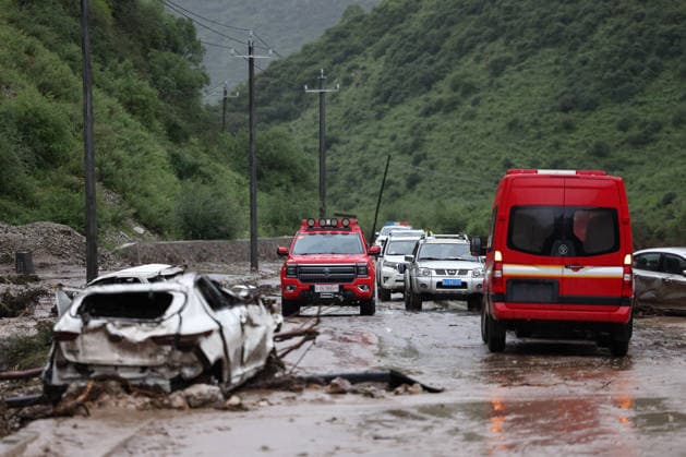 (260727) -- WEIYUAN, July 27, 2026 -- Rescue vehicles are seen at the flood-hit area in Weiyuan County, northwest China s Gansu Province, July 27, 2026. The flash flood, triggered by sudden heavy rainfall, hit a scenic area in Weiyuan County, Dingxi City, on Sunday afternoon, leaving 10 people dead and 23 injured as of 6 p.m. ? ?Some tourists were camping in the scenic area and were trapped after the flood burst out, local authorities said. ? ?A total of 305 rescue personnel with 68 vehicles from the national comprehensive fire and rescue teams are conducting rescue operations at the site, according to the MEM. ) (SpotNews) CHINA-GANSU-WEIYUAN-FLASH FLOOD-RESCUE AND RELIEF WORK (CN) ChenxBin 