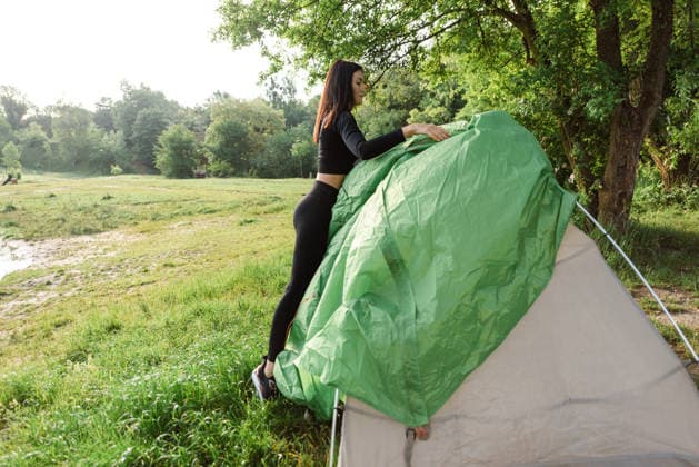 Athlete girl covering outer tent canvas on tent Lviv, Lviv Oblast, Ukraine R_JUCE2607234C-2087631-01 ,model released, Symbolfoto ,property released