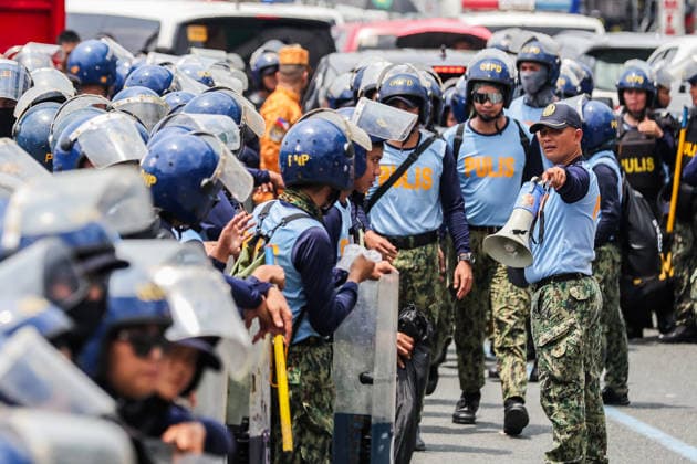 (260727) -- QUEZON CITY, July 27, 2026 -- Police officers from the Philippine National Police gather to block the path of protesters during a rally, as President Ferdinand Romualdez Marcos Jr. delivers his 5th State of the Nation Address (SONA) at the House of Representatives, in Quezon City, the Philippines, on July 27, 2026. Various sectors took to the streets to voice their grievances over government policies. ) THE PHILIPPINES-QUEZON CITY-STATE OF THE NATION ADDRESS-PROTEST RouellexUmali 