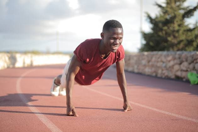Young Black man smiling while doing pushups outdoors Mellie?a, Northern Region, Malta R_MIPI26072288-2085491-01 ,model released, Symbolfoto ,property released