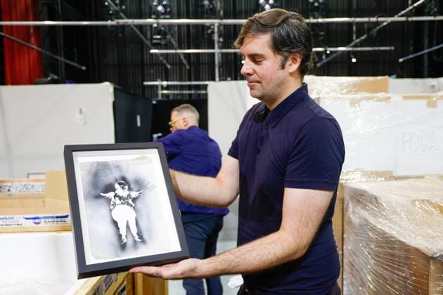 July 27, 2026, Tampa, Florida, USA: Fraser Goulding, an art installer, shows a stencil which was used to create an art piece from street artist, Banksy, at the Straz Center on Monday, July 27, 2026, in Tampa. Tampa USA - ZUMAs70_ 20260727_zan_s70_018 Copyright: xJeffereexWoox
