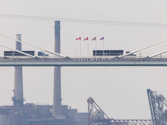 (260727) -- WINDSOR(CANADA), July 27, 2026 -- Trucks heading into the United States on the Gordie Howe International Bridge are pictured from the Canadian side in Windsor, Ontario, Canada, on July 27, 2026. Canada on Monday opened a new international bridge linking Windsor, Ontario and Detroit, U.S., providing the newest and largest land border crossing with the United States despite escalating trade tensions between the two countries. (Photo by Xinhua) CANADA-U.S.-BORDER BRIDGE-OPENING ZouxZheng 