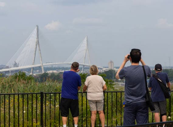 (260727) -- WINDSOR(CANADA), July 27, 2026 -- People view the Gordie Howe International Bridge from the Canadian side in Windsor, Ontario, Canada, on July 27, 2026. Canada on Monday opened a new international bridge linking Windsor, Ontario and Detroit, U.S., providing the newest and largest land border crossing with the United States despite escalating trade tensions between the two countries. (Photo by Xinhua) CANADA-U.S.-BORDER BRIDGE-OPENING ZouxZheng 