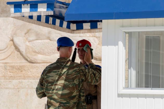 Athens Greece Heatwave A Greek soldier wipes sweat from a member of the Greek Presidential Guard during the changing of the guard ceremony at the Tomb of the Unknown Soldier outside the Hellenic Parliament in Athens, Attica, Greece on July 27, 2026. High summer temperatures persist in Athens. Athens Attica Greece Copyright: xElvisxTakahashixMantellox