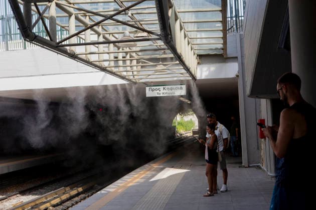 Athens Greece Heatwave People wait near water spray on the platform at Thiseio station in Athens, Attica, Greece on July 27, 2026. The water spray system operates as high summer temperatures persist in the Greek capital. Athens Attica Greece Copyright: xElvisxTakahashixMantellox