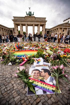 Menschen gedenken mit Blumen, Kerzen, Regenbogenflaggen und Solidaritätsnachrichten an den Opfer der Anschlag vom 25. Juli an den CSD vor dem Brandenburger Tor in Berlin am 27. Juli 2026. Der vermeintliche Attänteter Abdul B. soll mit einem LKW in dem Tiergarten gefahren und eine Frau getötet und weiter 29 Menschen verletzt haben. Gestern laut Polizei und LKA soll er während eine Operation in einer Gartenkolonie in Spandau aufgespürt und erschossen worden sein. Berliner gedenken an den Opfern der Attacke an den CSD *** People pay their respects with flowers, candles, rainbow flags, and messages of solidarity for the victims of the July 25 attack at the CSD in front of the Brandenburg Gate in Berlin on July 27, 2026. The alleged attacker, Ab
