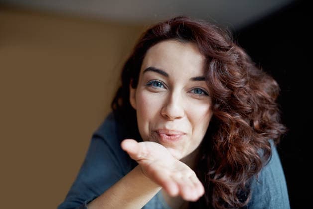 Blowing kiss, portrait and video call with woman in home for live streaming, social media or flirt. Broadcast pov, content creation or connection with person in house for recording, happy or greeting. model released property released Copyright: xx