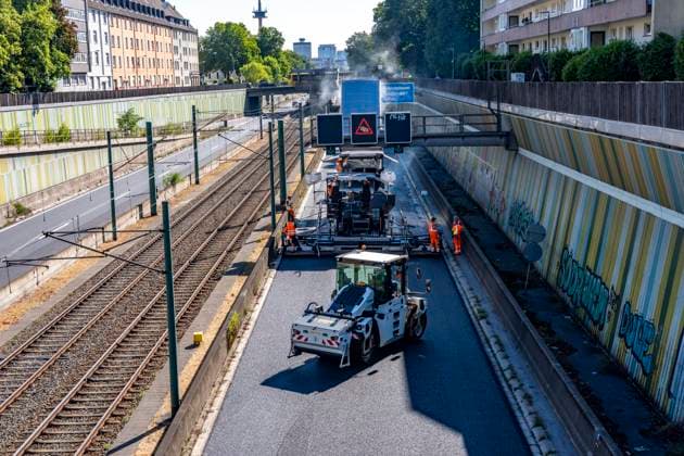 Sanierung der Autobahn A40 zwischen Mülheim-Winkhausen und Essen-Ost, auf 5,8 Kilometer wurde die Asphaltdecke erneuert, mit s.g. Flüsterasphalt, offenporiger Asphalt, in beide Fahrtrichtungen, insgesamt über 110.000 Quadratmeter, eine Woche Vollsperrung, mit starker Verkehrsbehinderungen im Ruhrgebiet, Essen, NRW, Deutschland Autobahnsanierung *** Renovation of the A40 highway between Mülheim Winkhausen and Essen Ost: The asphalt pavement was replaced over a 5.8-kilometer stretch with so-called whisper asphalt (open-pored asphalt) in both directions, totaling over 110,000 square meters; the highway was fully closed for one week, causing severe traffic disruptions in the Ruhr region, Essen, North Rhine-Westphalia, and Germany. Highway