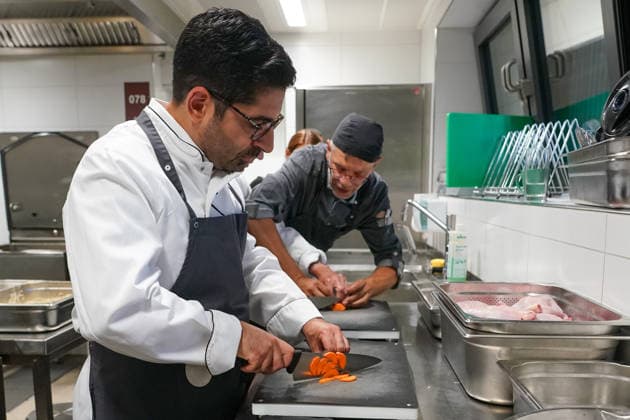 Hessens Wirtschaftsminister Kaweh Mansoori (SPD) und der Landrat des Kreis Groß-Gerau Thomas Will (SPD) bereiten in der Küche des AVM-Ausbildungsrestaurants Mangold in Bischofsheim ein Backhendl in Kürbiskern-Panade zu mit Küchenchef Florian Rothbauer - Bischofsheim 28.07.2026: Wirtschaftsminister Kaweh Mansoori besucht das Mangold *** Hesse’s Minister of Economic Affairs, Kaweh Mansoori (SPD), and Thomas Will (SPD), District Administrator of Groß Gerau, are preparing a fried chicken in a pumpkin seed breading in the kitchen of the AVM Mangold training restaurant in Bischofsheim with Head Chef Florian Rothbauer. Bischofsheim, July 28, 2026 Minister of Economic Affairs Kaweh Mansoori visits the Mangold
