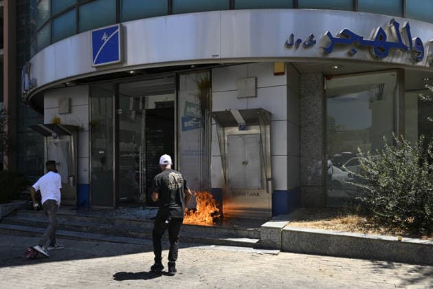 Depositors protest frozen savings at banks in Lebanon BEIRUT, LEBANON - JULY 28: Protesters light fires in front of a bank as people, who are unable to withdraw their money after all foreign currency deposit accounts in the country were frozen in 2019 to prevent the depletion of foreign exchange reserves, stage a protest in Beirut, Lebanon on July 28, 2026. Houssam Shbaro Anadolu Beirut Lebanon. Editorial use only. Please get in touch for any other usage.  Copyright: x2026xAnadoluxHoussamxShbarox