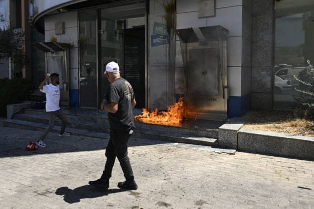 Depositors protest frozen savings at banks in Lebanon BEIRUT, LEBANON - JULY 28: Protesters light fires in front of a bank as people, who are unable to withdraw their money after all foreign currency deposit accounts in the country were frozen in 2019 to prevent the depletion of foreign exchange reserves, stage a protest in Beirut, Lebanon on July 28, 2026. Houssam Shbaro Anadolu Beirut Lebanon. Editorial use only. Please get in touch for any other usage.  Copyright: x2026xAnadoluxHoussamxShbarox