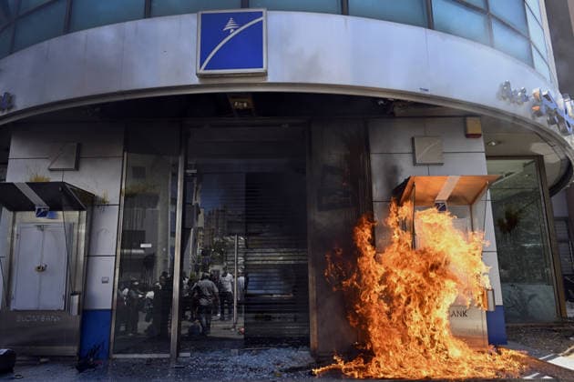 Depositors protest frozen savings at banks in Lebanon BEIRUT, LEBANON - JULY 28: Protesters light fires in front of a bank as people, who are unable to withdraw their money after all foreign currency deposit accounts in the country were frozen in 2019 to prevent the depletion of foreign exchange reserves, stage a protest in Beirut, Lebanon on July 28, 2026. Houssam Shbaro Anadolu Beirut Lebanon. Editorial use only. Please get in touch for any other usage.  Copyright: x2026xAnadoluxHoussamxShbarox