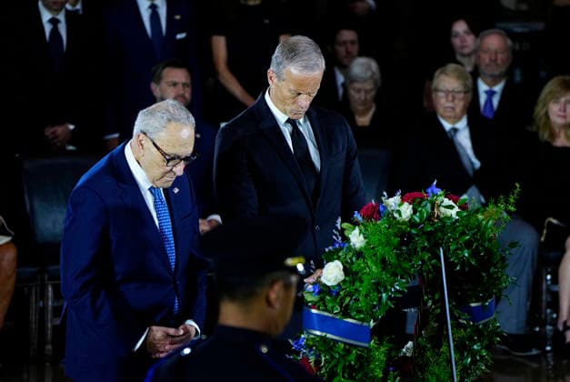 Senate Majority Leader John Thune (R) and Senate Minority Leader Chuck Schumer pay their respects during a Congressional Tribute to honor the late Sen. Lindsey Graham, R-SC, in the Rotunda of the U.S. Capitol in Washington, DC on Tuesday, July 28, 2026. Graham, who served in Congress for 31 years, died on July 11 at the age of 71.  WAP20260728933 BONNIExCASH