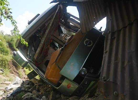 GANDERBAL, INDIA - JULY 28: A heavily damaged bus carrying Amarnath Yatra pilgrims rests along a steep embankment after skidding off the road and plunging into a deep gorge at the S-Mode stretch near Hariganiwan in the Gund area on July 28, 2026 in Ganderbal, India. The bus carrying around 40 pilgrims returning from the Baltal base camp toward Srinagar after performing darshan at the holy cave shrine, lost control while negotiating a treacherous curve. At least 39 pilgrims hailing from Madhya Pradesh, Rajasthan, and Delhi sustained injuries in the crash, which brought a swift multi-agency rescue operations. (Photo by Waseem Andrabi Hindustan Times) 39 Injured After Bus Carrying Amarnath Pilgrims Skids In Ganderbal
