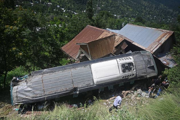 GANDERBAL, INDIA - JULY 28: A heavily damaged bus carrying Amarnath Yatra pilgrims rests along a steep embankment after skidding off the road and plunging into a deep gorge at the S-Mode stretch near Hariganiwan in the Gund area on July 28, 2026 in Ganderbal, India. The bus carrying around 40 pilgrims returning from the Baltal base camp toward Srinagar after performing darshan at the holy cave shrine, lost control while negotiating a treacherous curve. At least 39 pilgrims hailing from Madhya Pradesh, Rajasthan, and Delhi sustained injuries in the crash, which brought a swift multi-agency rescue operations. (Photo by Waseem Andrabi Hindustan Times) 39 Injured After Bus Carrying Amarnath Pilgrims Skids In Ganderbal